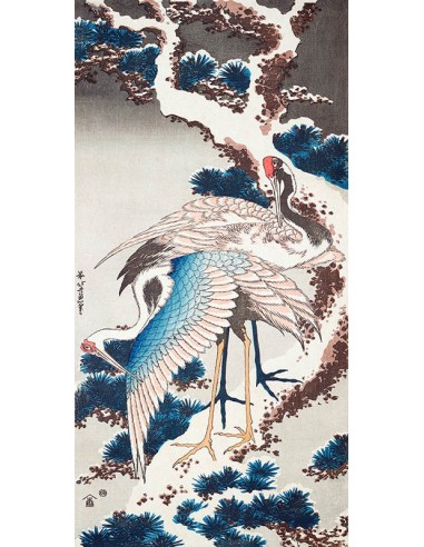 Grúas en un árbol nevado